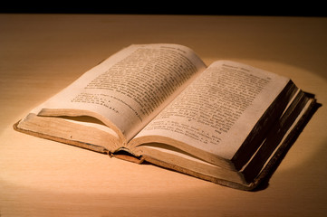 Fototapeta premium Old book in the spot of the light.