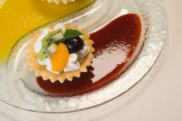butter cookie with whipped cream and fruit sauce