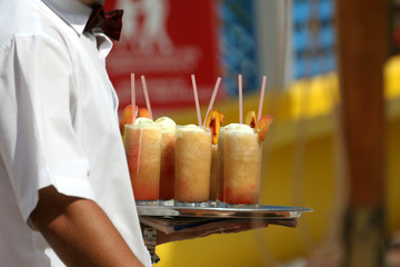 Waiter with fruit cocktails