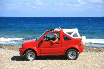 Fototapeta na wymiar Man in red jeep