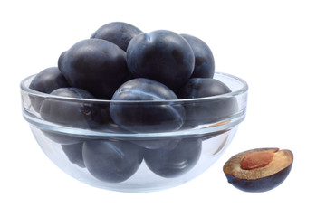 Glass bowl full of plums