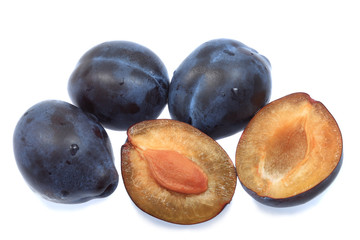 Three plums and one halved