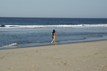 a young woman runs for the together beach to the sea ll...