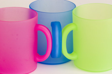 three colorful picnic mugs