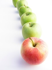 red and green apples in a row