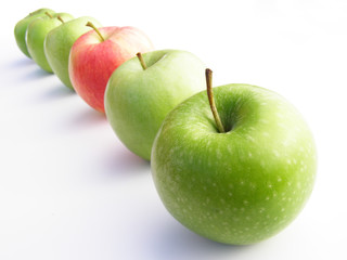 red and green apples in a row