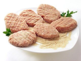 raw veal cutlets before frying 