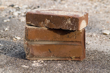 3 red bricks, on top of another.