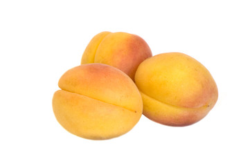 Three apricots on isolated white