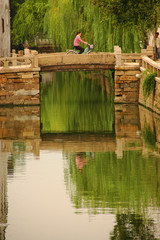 Cyclist on canal bridge