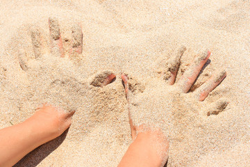 Hands buried in sand