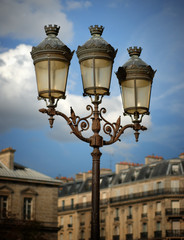 Fototapeta na wymiar Lamps Against a Partly Cloudy Sky, Notre Dame Cathedral