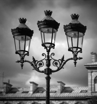 Black and White Image of Lamps Against a Cloudy Sky