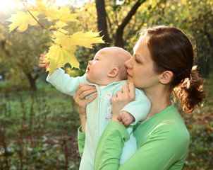 Mother and baby in the autumnal park