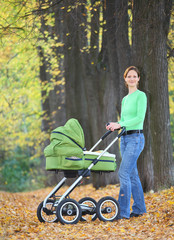 Mother and baby in the autumnal park.