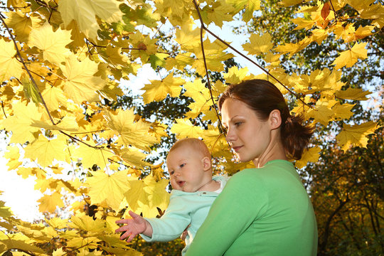 Mother and baby in the autumnal park
