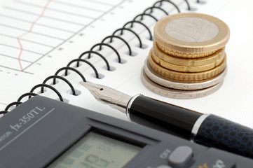 Stock chart, coin, pen and calculator