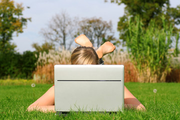 Girl using laptop outdoors