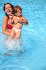 mother with daughter in the pool