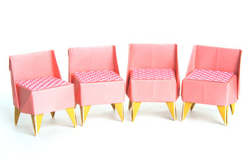Four origami chairs on a white background