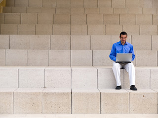 hispanic businessman with laptop