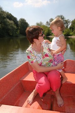 mom and daughter in the boan on the river