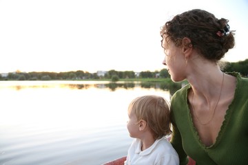 woman and little girl look at the river