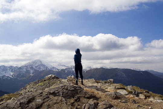 Young girl looking over high mountains