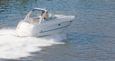 white speedboat motor boat  at the height of summer