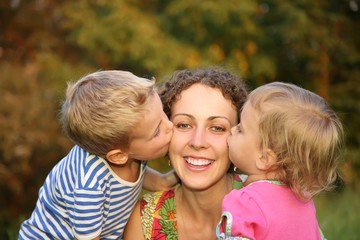 Fototapeta premium children kissing mother