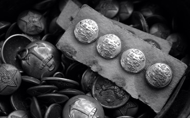 Vintage uniform buttons for sale in a market