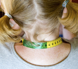 girl with tape measure around neck