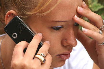 Teenager thoughtful on a mobile phone