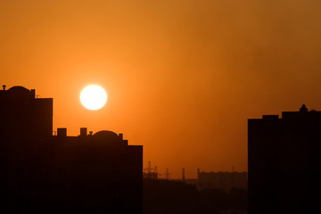 Fototapeta na wymiar Red sunset in a city