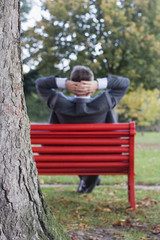 Businessman relaxing in a park