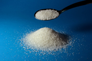 Heap of sugar and a spoon