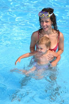 mother with daughter in pool