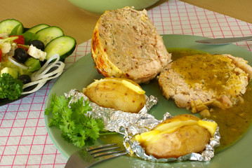 Stuffed chicken roll with potatoes baked in foil