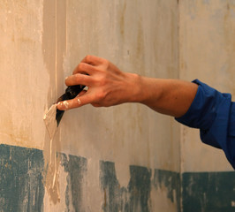 human arm(hand) repairs a wall