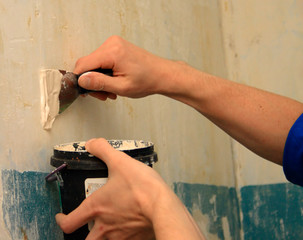 human arm repairs a wall