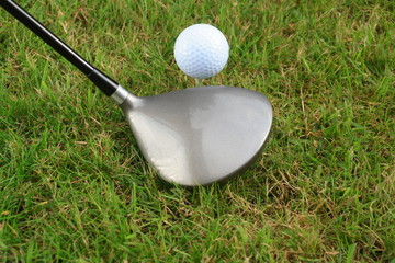 Driver and golf ball on a tee peg text space