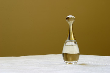Antique perfume bottle on white tablecloth