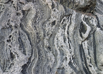 Convoluted, weathered rock, dark cleft at upper right