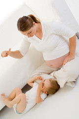 Obraz na płótnie Canvas Pregnant playing with child