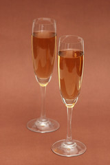 Two wine glasses on the  biege background