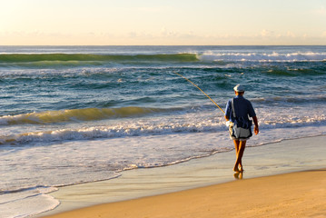 Beach Fisherman by Ocean as Sun rises