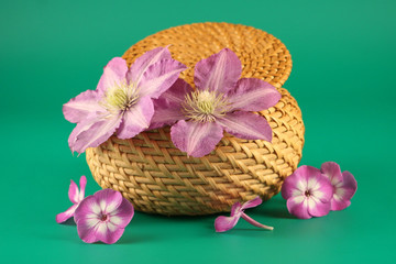Basket with flowers on a green  background
