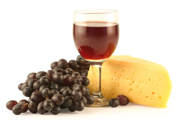 Grapes, cheese and a glass with red wine isolated on white.