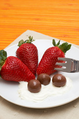 Strawberries and cream with chocolate balls