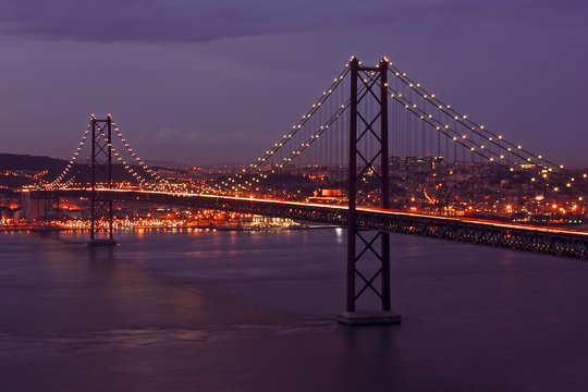 Suspension bridge by twilight near Lisbon in Portugal - Powered by Adobe